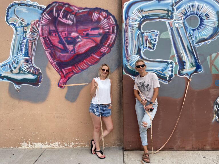 Two longtime friends by an I Love El Paso mural