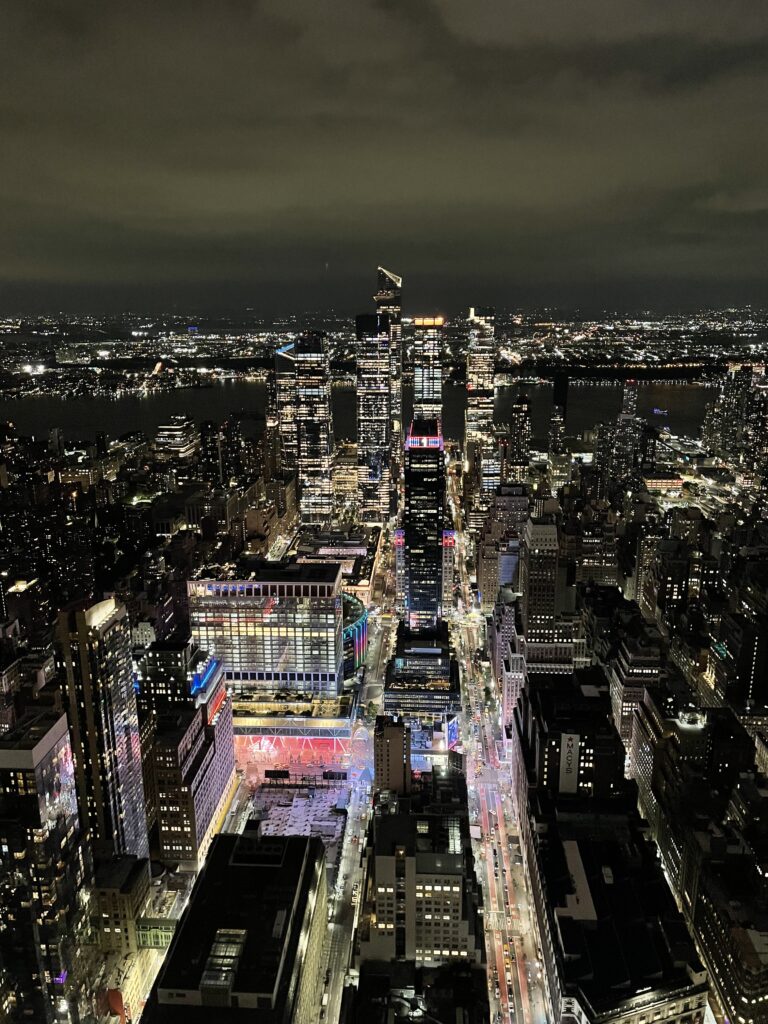 Night view over Midtown Manhattan from the Empire State Building observation deck.