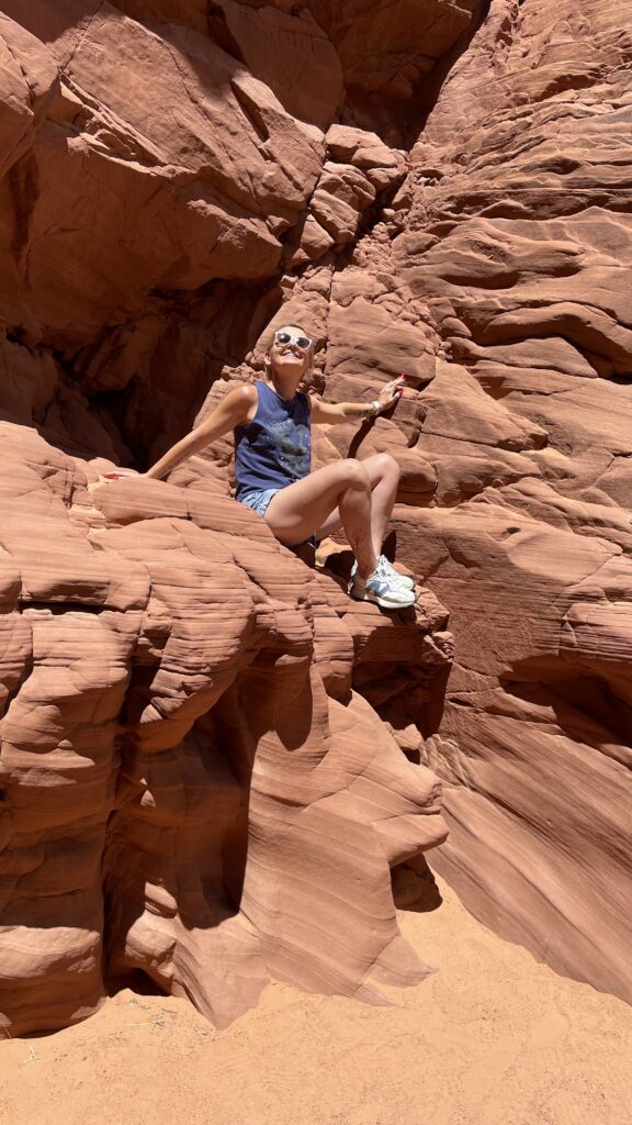 Woman exploring the sandstone formations at Upper Antelope Canyon in Arizona.