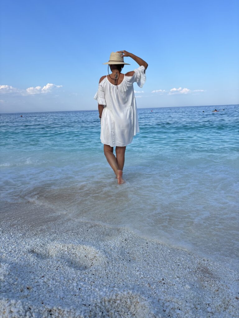 Woman walking into the sea on Thassos, Greece.